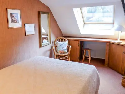a bedroom with a bed and a window and a chair at Apartment Jonquilles-15 by Interhome in Chamonix-Mont-Blanc