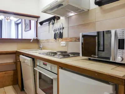 a kitchen with a microwave and a stove at Apartment Jonquilles-15 by Interhome in Chamonix-Mont-Blanc