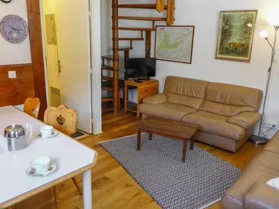 a living room with a couch and a table at Apartment Jonquilles-15 by Interhome in Chamonix-Mont-Blanc