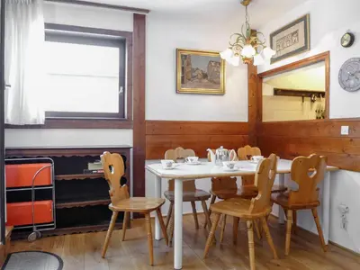 a dining room with a white table and chairs at Apartment Jonquilles-15 by Interhome in Chamonix-Mont-Blanc