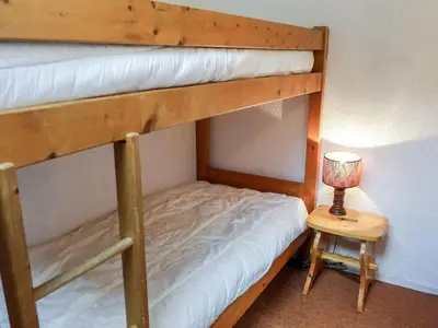 a bedroom with a bunk bed with a lamp and a table at Apartment Jonquilles-15 by Interhome in Chamonix-Mont-Blanc