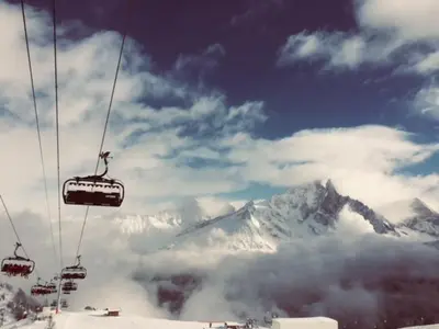 a ski lift flying over a snow covered mountain at Chamois Blanc in Chamonix-Mont-Blanc