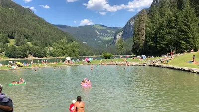 a group of people swimming in a lake at Giffre in Samoëns