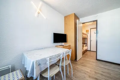 a room with a table with a tv and a bed at Giffre in Samoëns