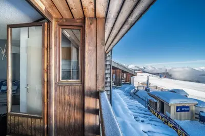 a train station with snow on the tracks at Giffre in Samoëns