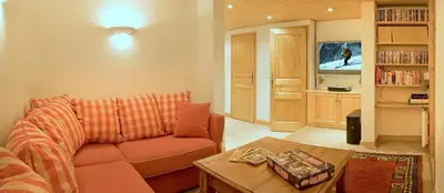 a living room with a couch and a table at Chalet Rimaye - Chamonix in Chamonix-Mont-Blanc