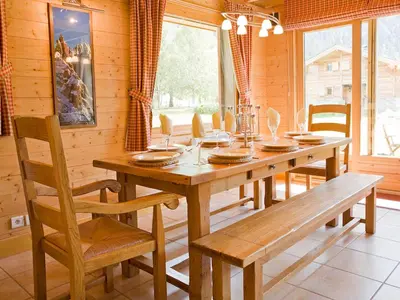 a dining room with a wooden table and chairs at Chalet Rimaye - Chamonix in Chamonix-Mont-Blanc
