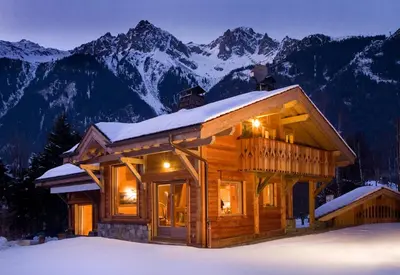 a log cabin in the snow with mountains at Chalet Rimaye - Chamonix in Chamonix-Mont-Blanc