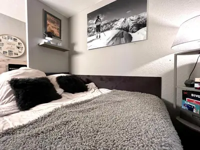 a bedroom with a bed with two pillows on it at Rocky Studio Chamonix Sud in Chamonix-Mont-Blanc