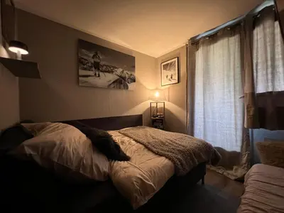 a bedroom with a bed and a window at Rocky Studio Chamonix Sud in Chamonix-Mont-Blanc