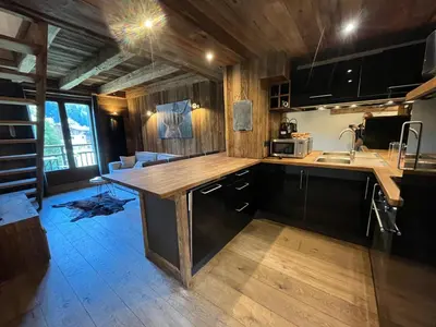 a kitchen with a wooden counter top in a room at Appartement du Petit Bois in Megève