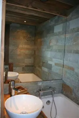 a bathroom with a sink and a bath tub at Appartement du Petit Bois in Megève