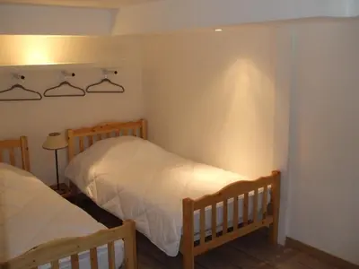 a bedroom with two beds and a lamp at joli T3 proche centre et télécabines in Saint-Gervais-les-Bains