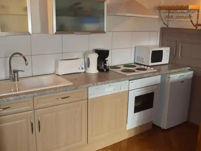 a kitchen with a sink and a stove top oven at joli T3 proche centre et télécabines in Saint-Gervais-les-Bains