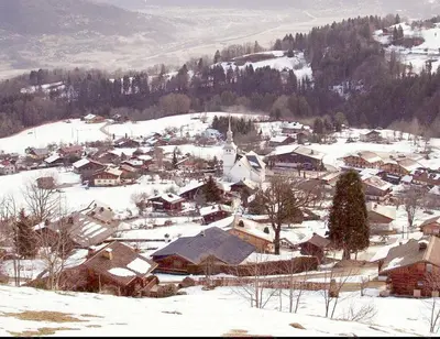 a small town covered in snow with houses at Cordon Balcon Du Mont Blanc in Cordon