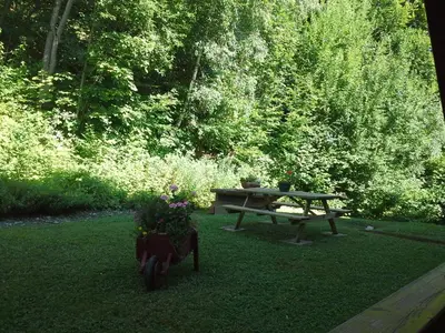 a picnic table and a bench and flowers in the grass at Cordon Balcon Du Mont Blanc in Cordon