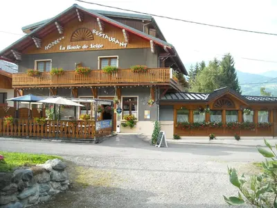 a building with a balcony with flowers on it at La Boule de Neige in Samoëns