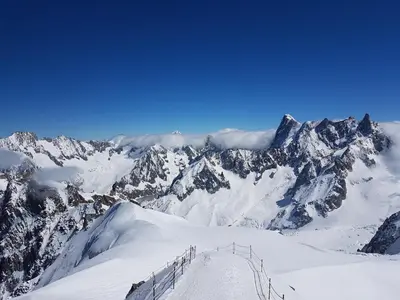 a view of a snowy mountain with a ski lift at Le Sapi 1E Balcon panoramique Aiguilles Rouges avec parking gratuit in Chamonix-Mont-Blanc