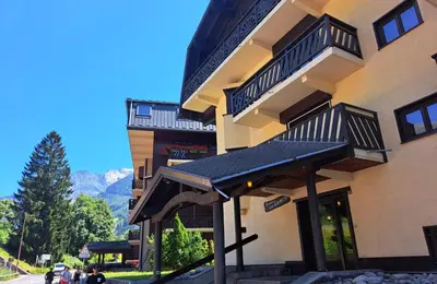 a building with a black awning in front of it at Le Sapi 1E Balcon panoramique Aiguilles Rouges avec parking gratuit in Chamonix-Mont-Blanc