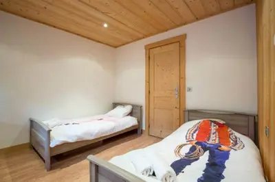 a bedroom with two beds and a wooden ceiling at Résidence Mont Joly2 in Saint-Gervais-les-Bains