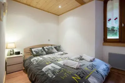 a bedroom with a bed with posters on it at Résidence Mont Joly2 in Saint-Gervais-les-Bains