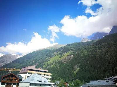 a view of a mountain range with houses and mountains at La Cabane in Chamonix-Mont-Blanc