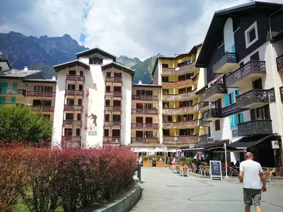 a man walking down a street next to buildings at La Cabane in Chamonix-Mont-Blanc