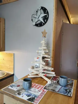 a christmas tree on a table with a clock at La Cabane in Chamonix-Mont-Blanc