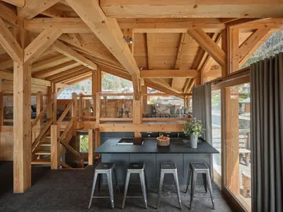 a wooden house with a table and stools at Les Rives d'Argentière in Chamonix-Mont-Blanc