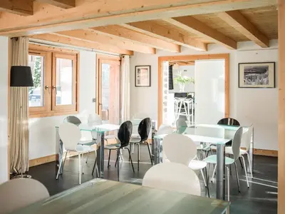 a dining room with white tables and chairs at Les Rives d'Argentière in Chamonix-Mont-Blanc