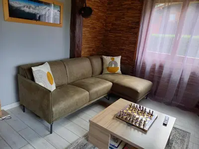 a living room with a couch and a coffee table at Appartement avec Terrasse in Chamonix-Mont-Blanc