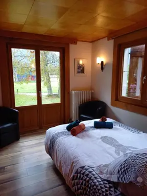 a bedroom with a bed with a teddy bear on it at Appartement avec Terrasse in Chamonix-Mont-Blanc