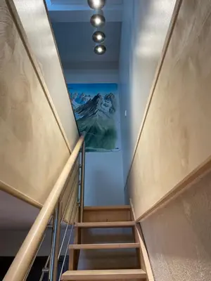 a staircase in a building with a painting on the wall at Residence La Verte 24- Aux Pieds des pistes! in Chamonix-Mont-Blanc