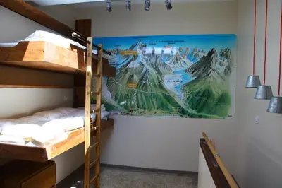 a room with bunk beds and a poster on the wall at Residence La Verte 24- Aux Pieds des pistes! in Chamonix-Mont-Blanc