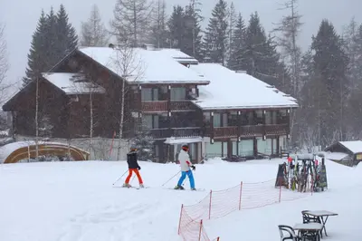two people cross country skiing in front of a lodge at Residence La Verte 24- Aux Pieds des pistes! in Chamonix-Mont-Blanc