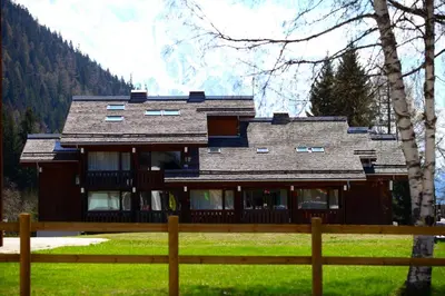 a large house with a fence in front of it at Residence La Verte 24- Aux Pieds des pistes! in Chamonix-Mont-Blanc
