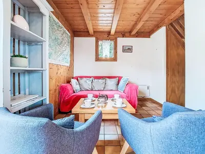 a living room with a red couch and a table at Holiday Home Les Farfadets by Interhome in Saint-Gervais-les-Bains