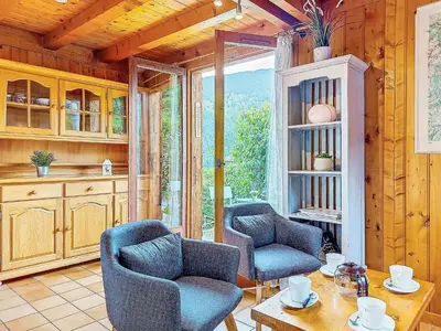 a kitchen with a white table and chairs and wooden walls at Holiday Home Les Farfadets by Interhome in Saint-Gervais-les-Bains