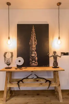 a table with a painting and a lamp on it at Appartement Native in Chamonix-Mont-Blanc