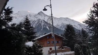 a building in front of a snow covered mountain at Appartement Native in Chamonix-Mont-Blanc