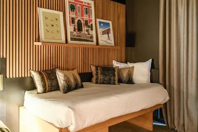 a bed with pillows on it in a room at La Folie Douce Hotels Chamonix in Chamonix-Mont-Blanc