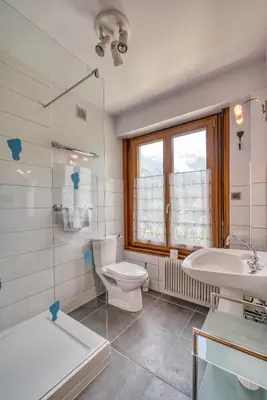 a bathroom with a toilet and a sink and a tub at Aran Apartment - Chamonix in Chamonix-Mont-Blanc