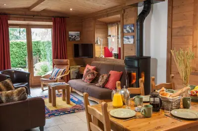 a living room with a table and a fireplace at Petite Savoyarde - Chamonix in Chamonix-Mont-Blanc