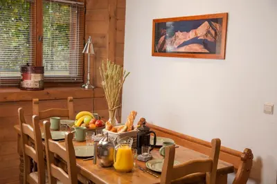 a wooden table with fruit and vegetables on it at Petite Savoyarde - Chamonix in Chamonix-Mont-Blanc