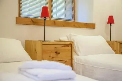 a bedroom with two beds and a red lamp at Petite Savoyarde - Chamonix in Chamonix-Mont-Blanc