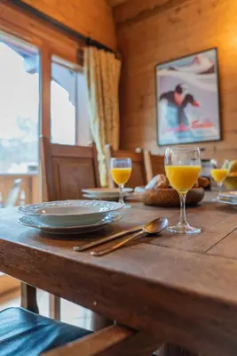 a wooden table with glasses of orange juice on it at Clos 3 - Chamonix in Chamonix-Mont-Blanc