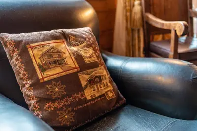 a brown pillow sitting on a leather chair at Clos 3 - Chamonix in Chamonix-Mont-Blanc