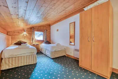 a bedroom with two beds and a wooden ceiling at Clos 3 - Chamonix in Chamonix-Mont-Blanc