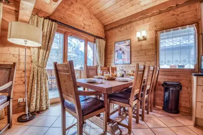 a dining room with a wooden table and chairs at Clos 3 - Chamonix in Chamonix-Mont-Blanc