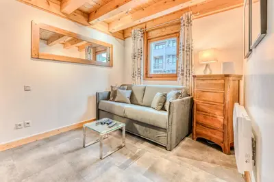 a living room with a couch and a table at Morgane Apartment in Chamonix-Mont-Blanc